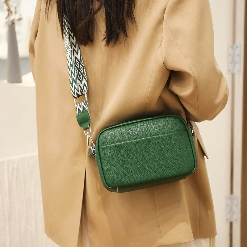 Stylish crossbody bag with rhombus embroidery, wide adjustable shoulder strap, and multiple interior pockets in various color options