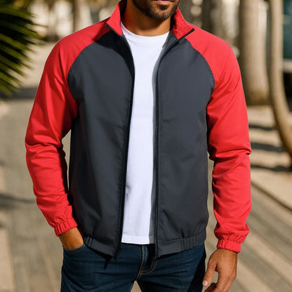 Man wearing a green loose-fit casual jacket with a stand collar and raglan long sleeves.