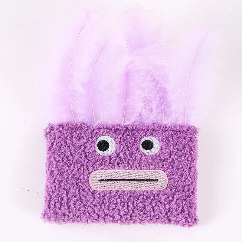 Colourful plush cat toy shaped like an explosion head with a large open mouth, shown in blue.