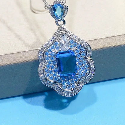 Geometric sea blue copper pendant charm on a white background.