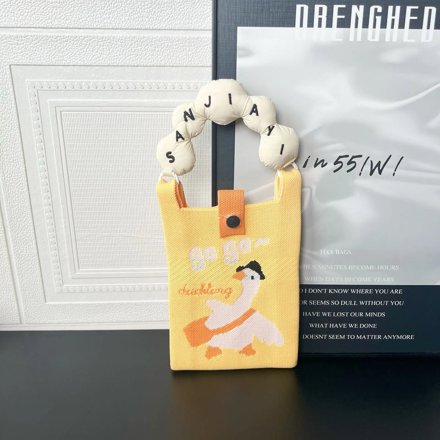 Cartoon knitted messenger bag with polyester construction and internal mobile phone storage