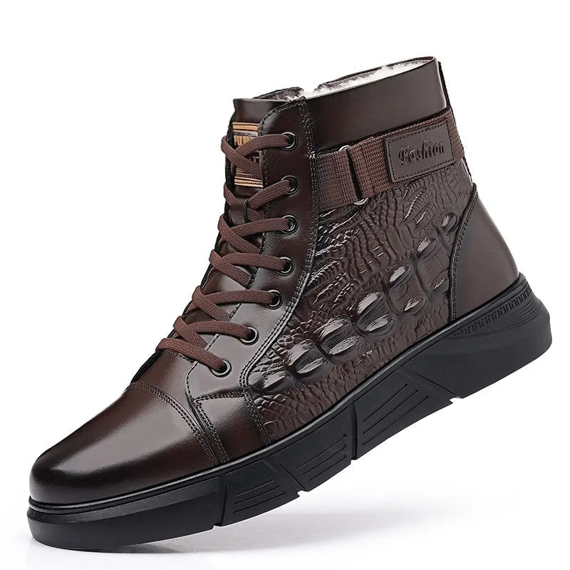 Men's brown genuine leather lace-up snow boots with fur lining and deep-tread rubber sole on a wooden surface.