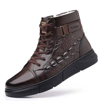 Men's brown genuine leather lace-up snow boots with fur lining and deep-tread rubber sole on a wooden surface.