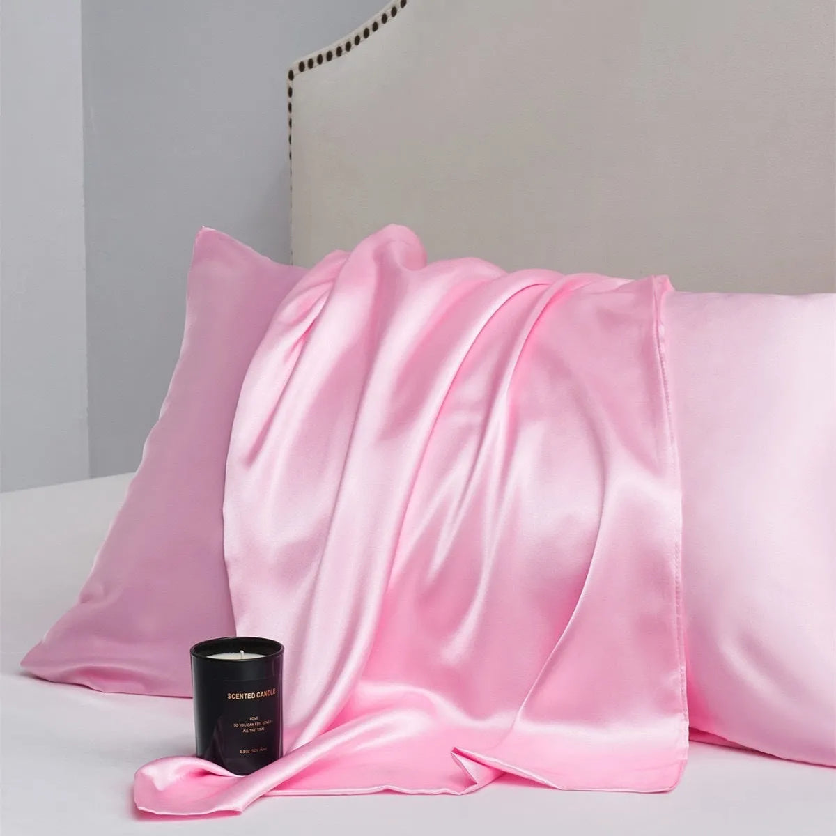 Pair of solid colour satin pillowcases showing smooth plain weave texture and reactive dye colour