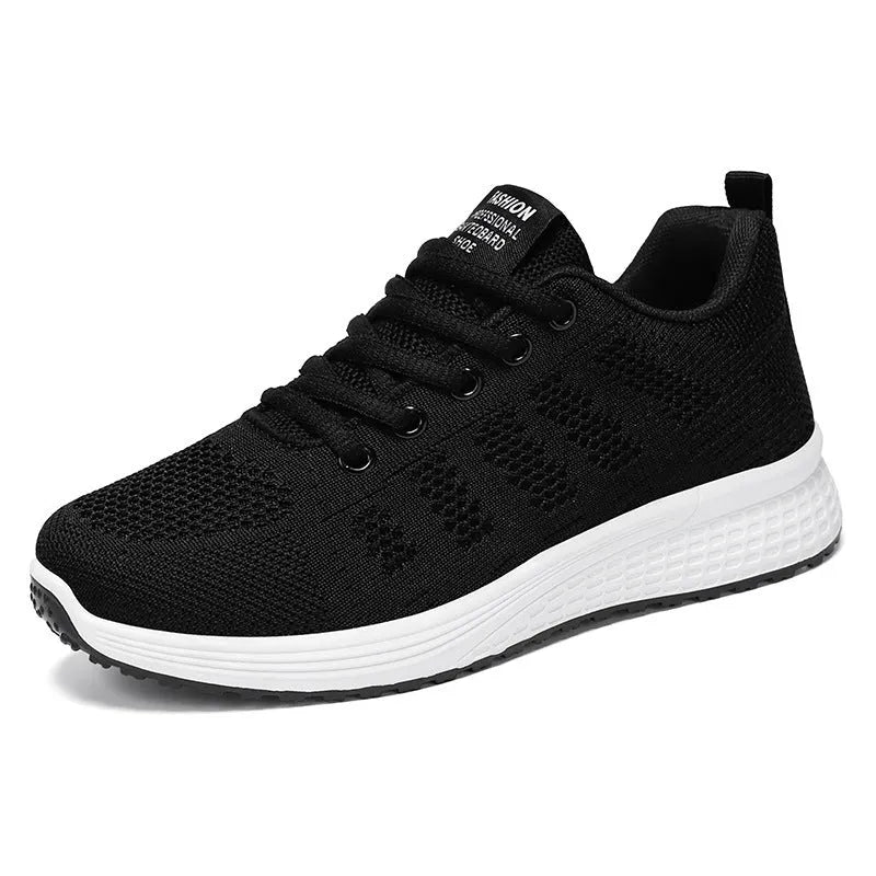Women's flyknit running shoes in grey pink with soft sole and lace-up front.