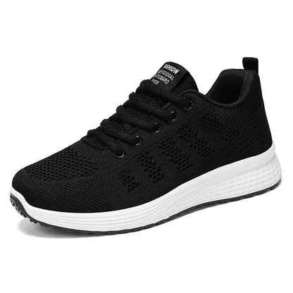 Women's flyknit running shoes in grey pink with soft sole and lace-up front.