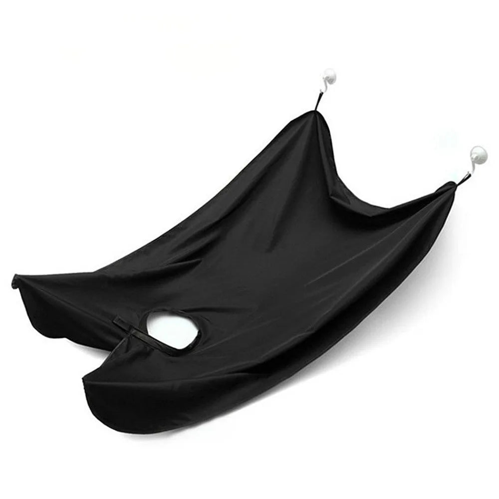 Professional transparent barber shaving cape with built-in tool tray and suction cup, shown in black.