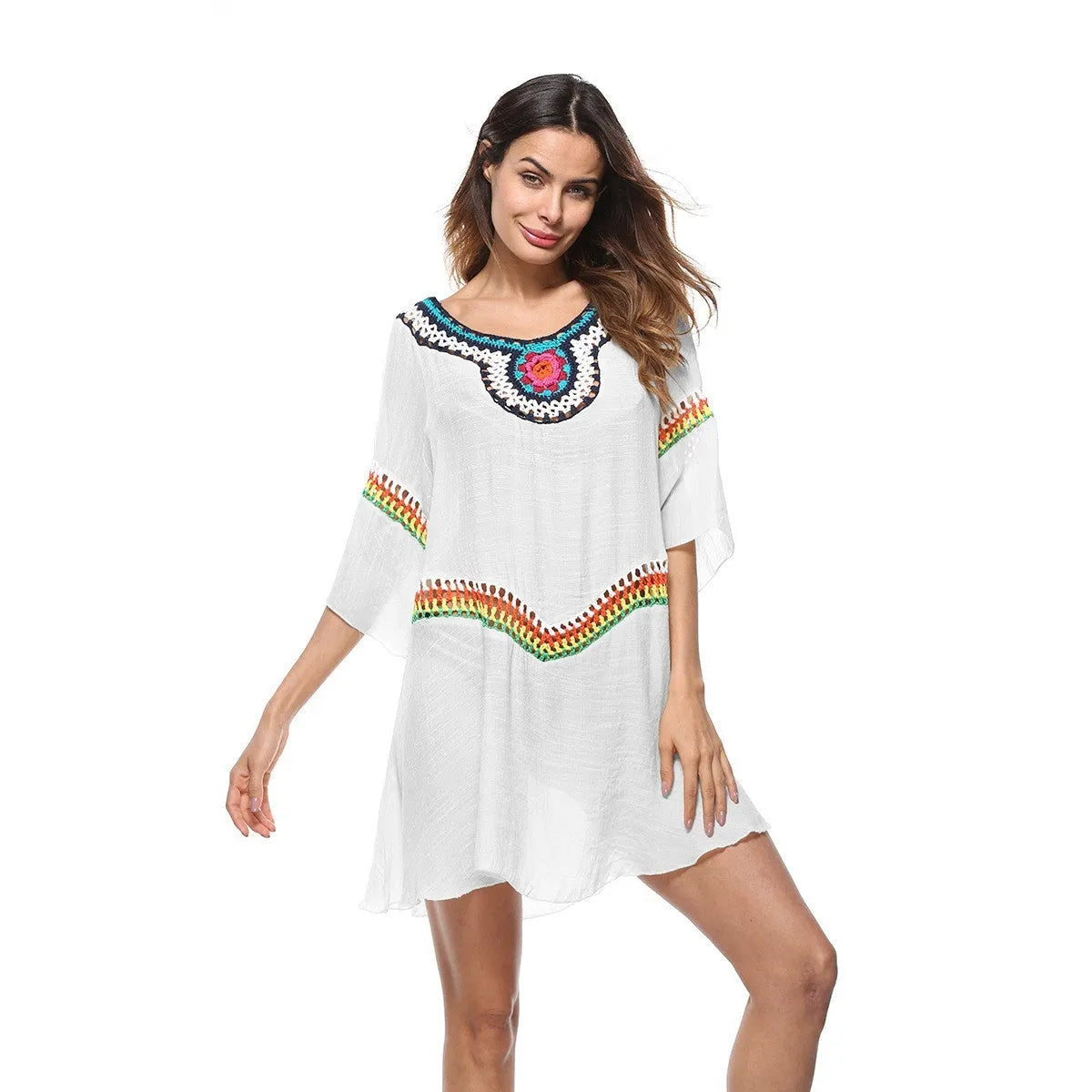 Crocheted white beach cover-up with open-knit design, worn over swimsuit, demonstrating UPF 50+ sun protection.