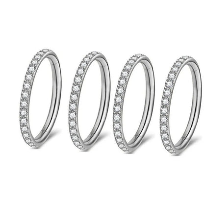 A seamless round hoop nose ring in stainless steel, shown alongside gold and rose gold colour options.