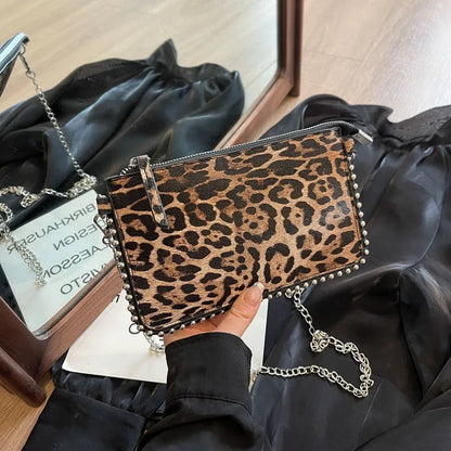 Western style women's brown crossbody bag with chain strap and horizontal square silhouette