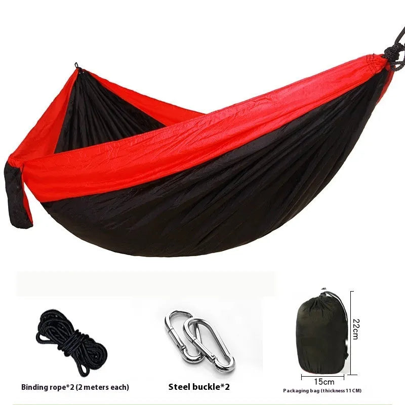 Parachute cloth double camping hammock in chosen colour, with black buckles and round ropes on a tree.