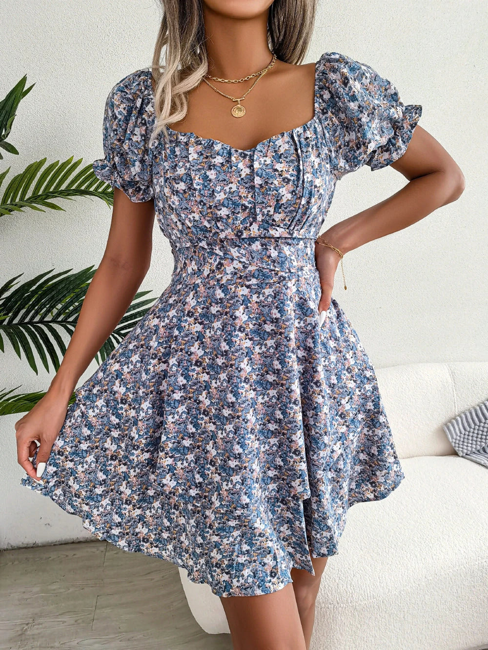 Stylish floral mini dress with ruffled skirt, high-waist design, and short sleeves for a flattering and comfortable summer look