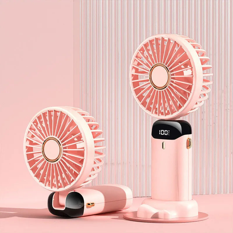 Blue foldable mini handheld electric fan showing its LED display and hanging lanyard.