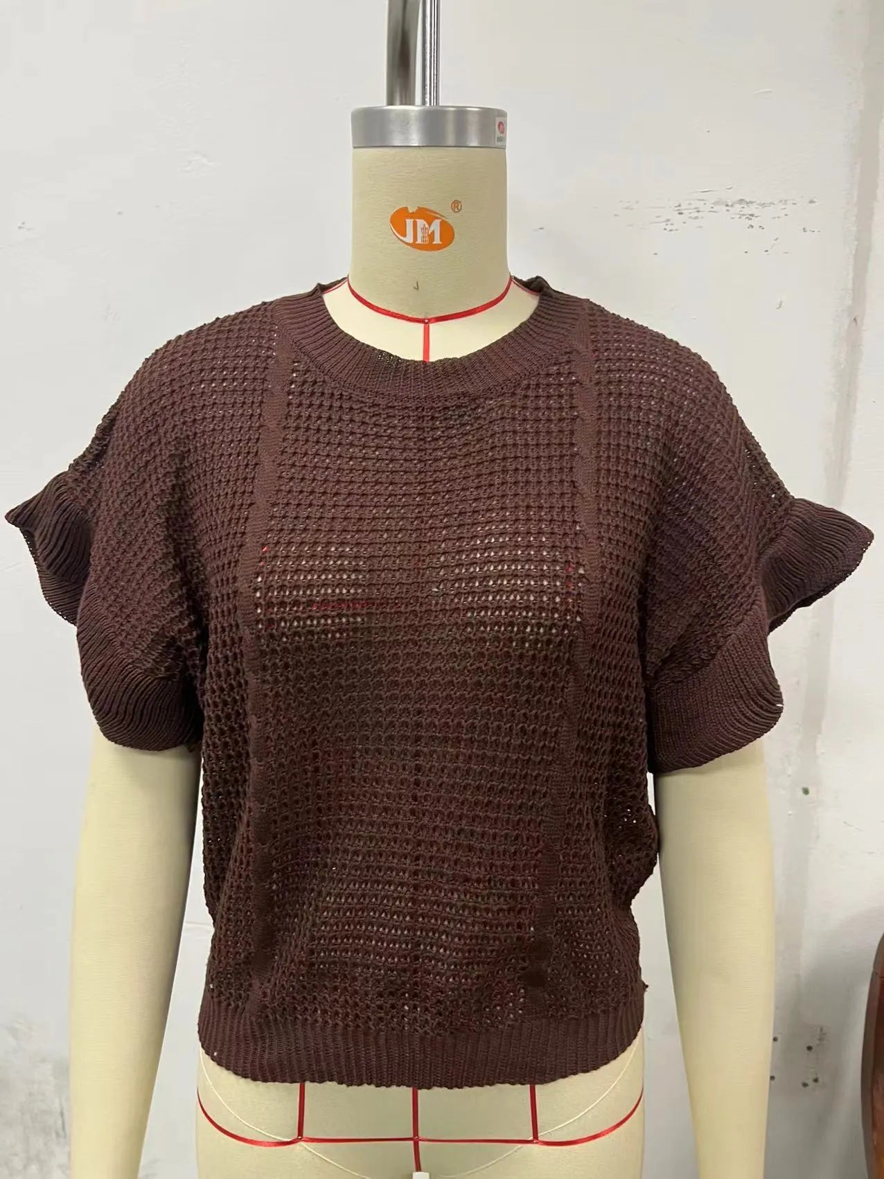 Loose round neck knitted pullover sweater with twisted string ruffled short sleeves in dark brown.