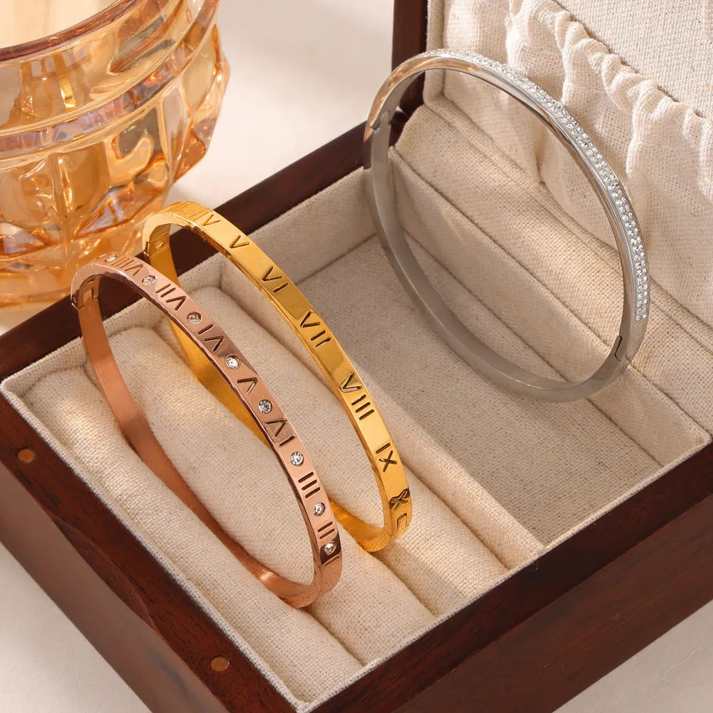 Titanium steel Roman numeral bracelet with gold plated carved design and diamond-embedded detail