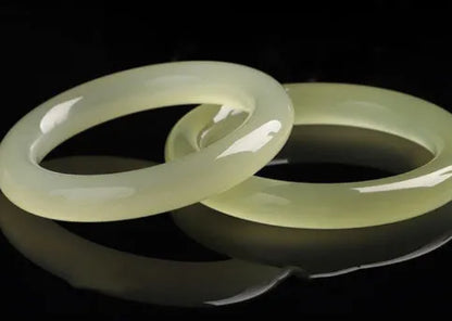 Ice silk jade round bar bracelet shown on a wrist, highlighting its smooth cylindrical shape and natural stone material.