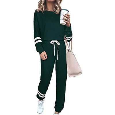 Women's loose-fitting plus size casual suit in a cotton blend, shown in a solid colour with a half-sleeve top and trousers.