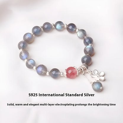 Close-up of a women's 925 silver bracelet with a 7.5mm grey moonlight strawberry stone and honeysuckle zodiac design.