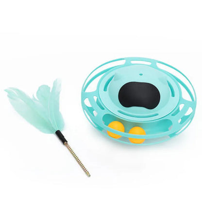 Pink self-hi tumbler cat toy with plush element on a turntable base, next to a play stick.