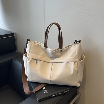 Nylon crossbody bag in five colours with 39x14x28cm dimensions and shoulder strap