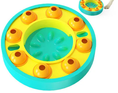 Square lake blue dog puzzle feeder with central column and rotating roulette top on a kitchen floor