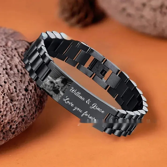 Men's titanium steel bracelet with curved heart shape and black electroplated lettering on wrist.