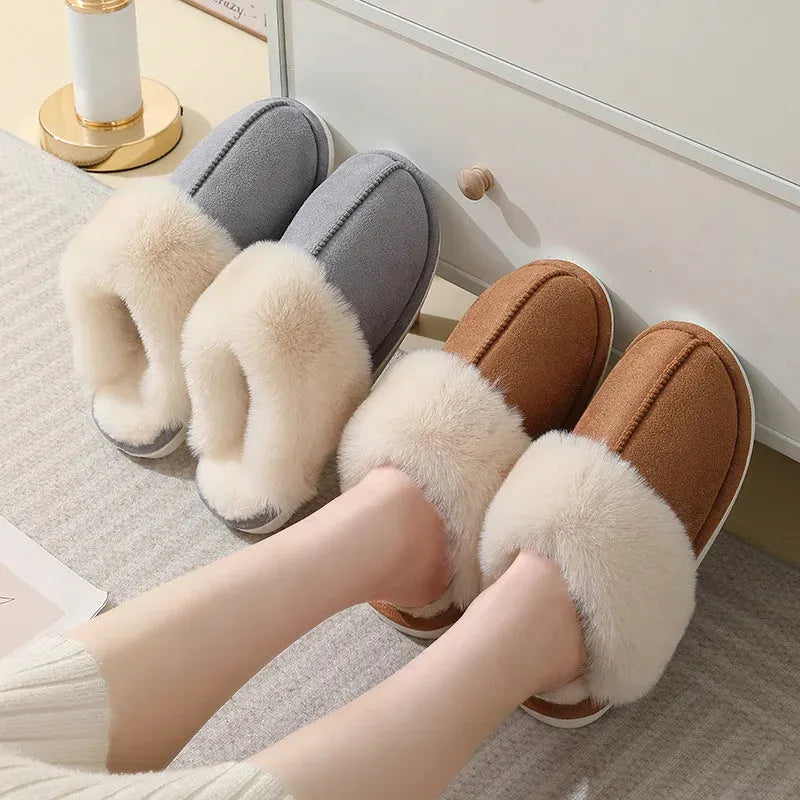 Women's plush winter slippers with round toe, flat heel, and stitching detail on a non-slip PVC sole.
