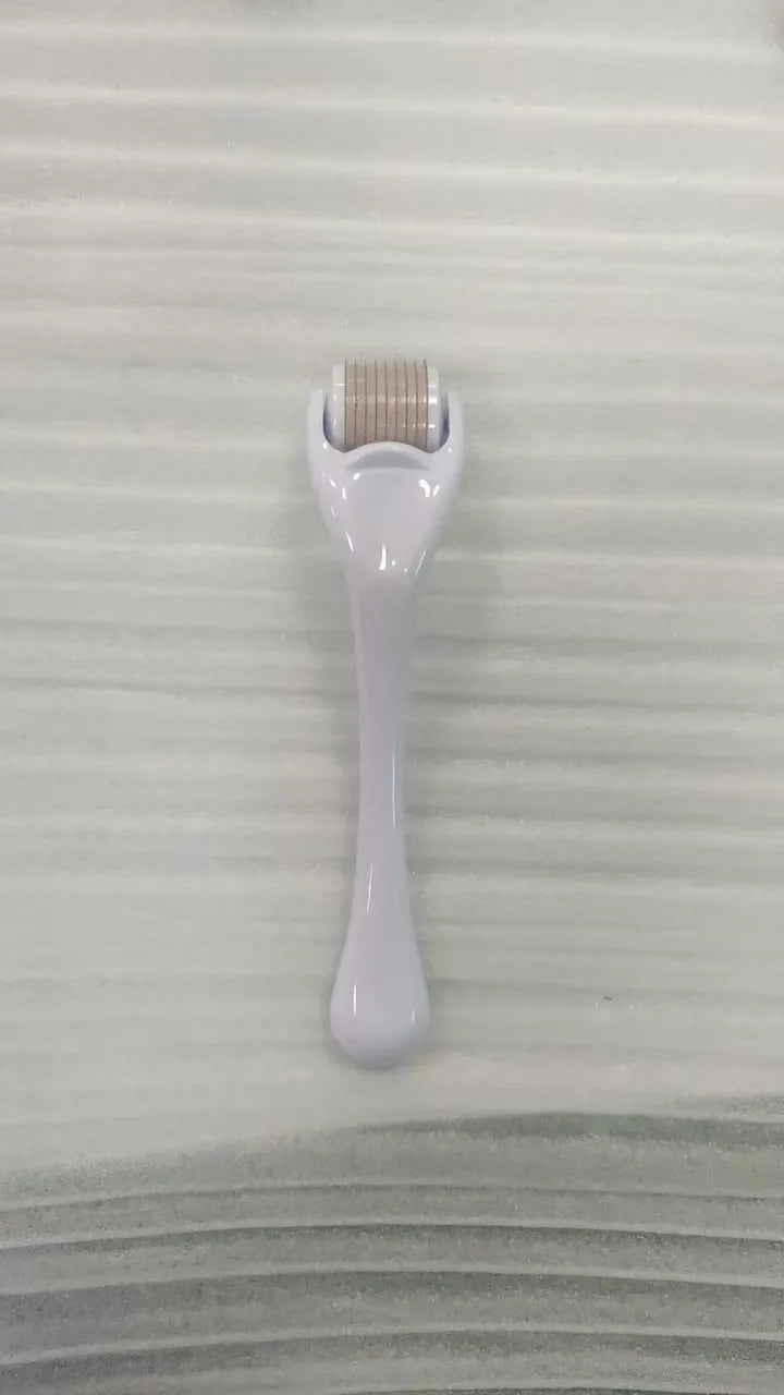 Sterile micro needle derma roller with black handle and coloured wheel on white background