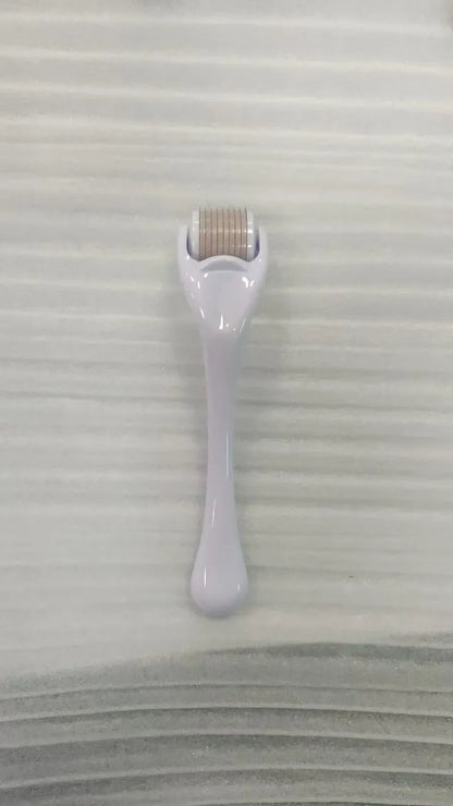 Sterile micro needle derma roller with black handle and coloured wheel on white background