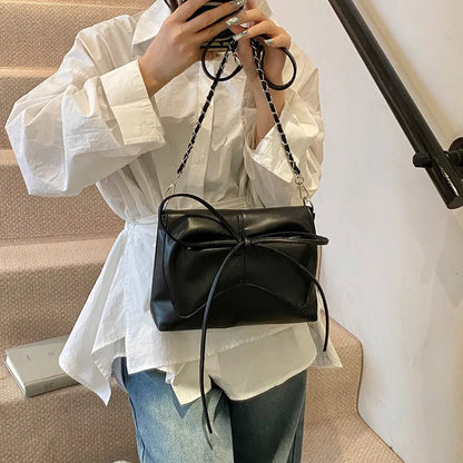 Black horizontal square PU crossbody bag showing internal mobile phone pocket and crossbody strap