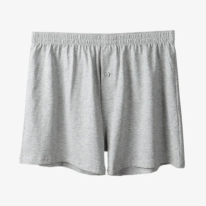 Men's light grey cotton boxer shorts with a loose fit and high waist on a plain background.