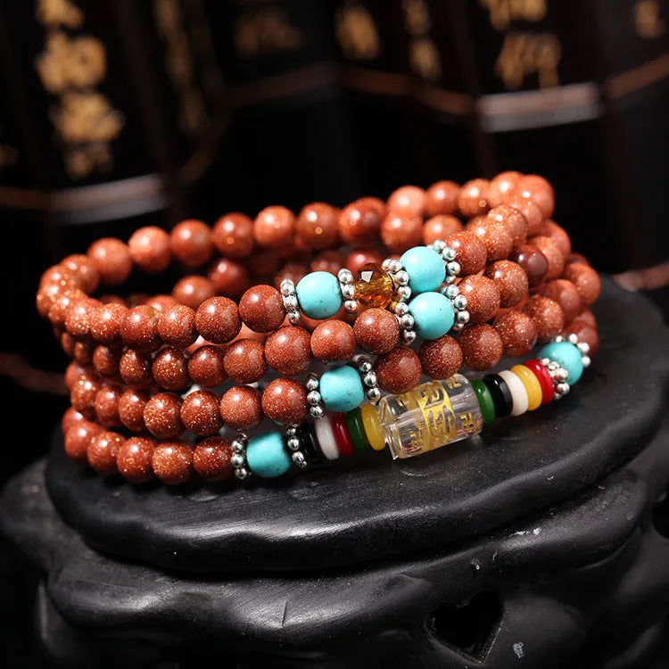 Women's golden star stone colour bracelet with 108 nugget sand pieces showing mantra text and fu character design