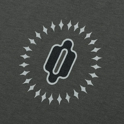 Woman wearing a grey khaki loose drop shoulder sweatshirt with a printed letter design.