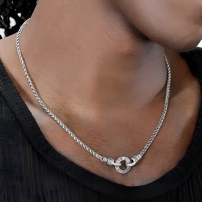 A simple sterling silver clavicle necklace with a small pendant, shown on a model.