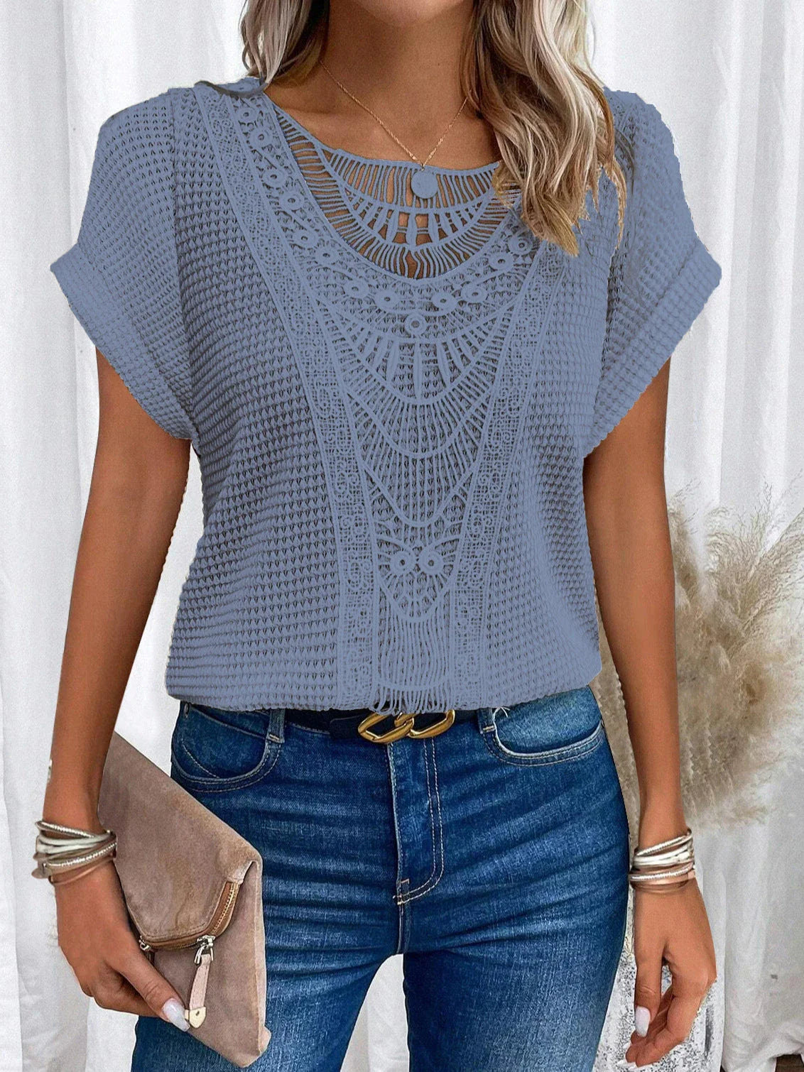 A stylish and comfortable short-sleeve t-shirt for women, featuring a unique hollowed-out design and breathable polyester fabric.