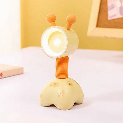 Colourful cartoon character magnetic DIY night light on a desk with adjustable head.