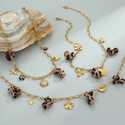 Women's adjustable stainless steel necklace with geometric leopard pendant featuring heart and flower decorative elements