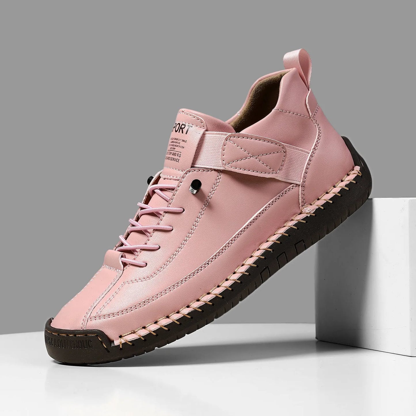 Men's black mid-top Martin boots with elastic band and sewn sole on a plain background.