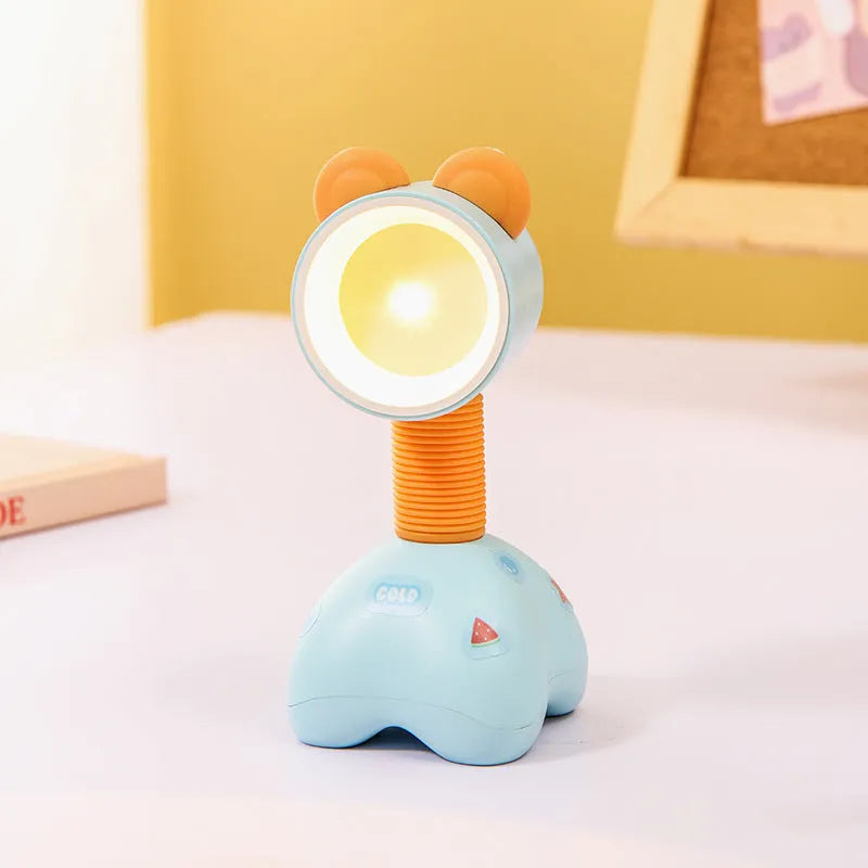 Colourful cartoon character magnetic DIY night light on a desk with adjustable head.