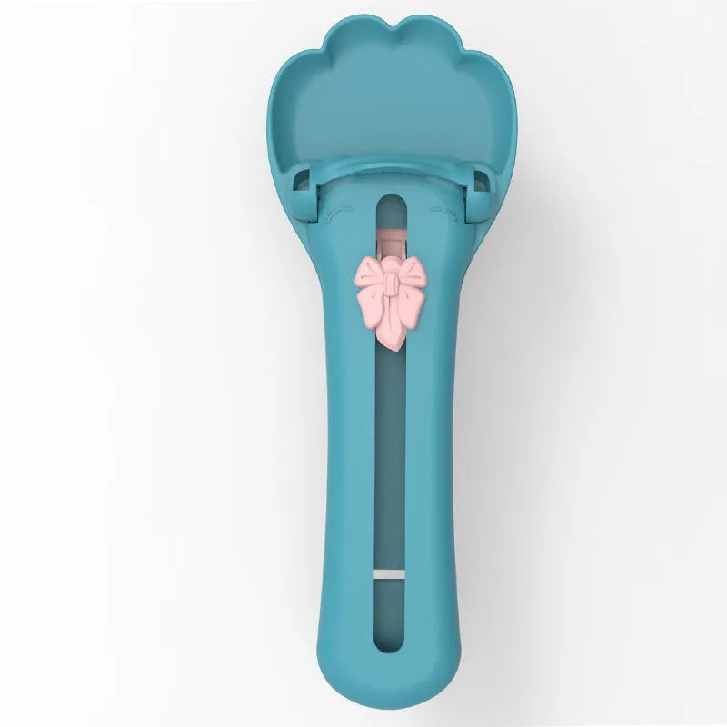 Green plastic pet food scoop with squeezer handle and dispensing nozzle for kibble and liquid.