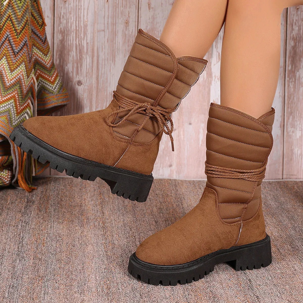 Women's black suede snow boots with chunky heel, fleece lining, and lace-up design for winter wear
