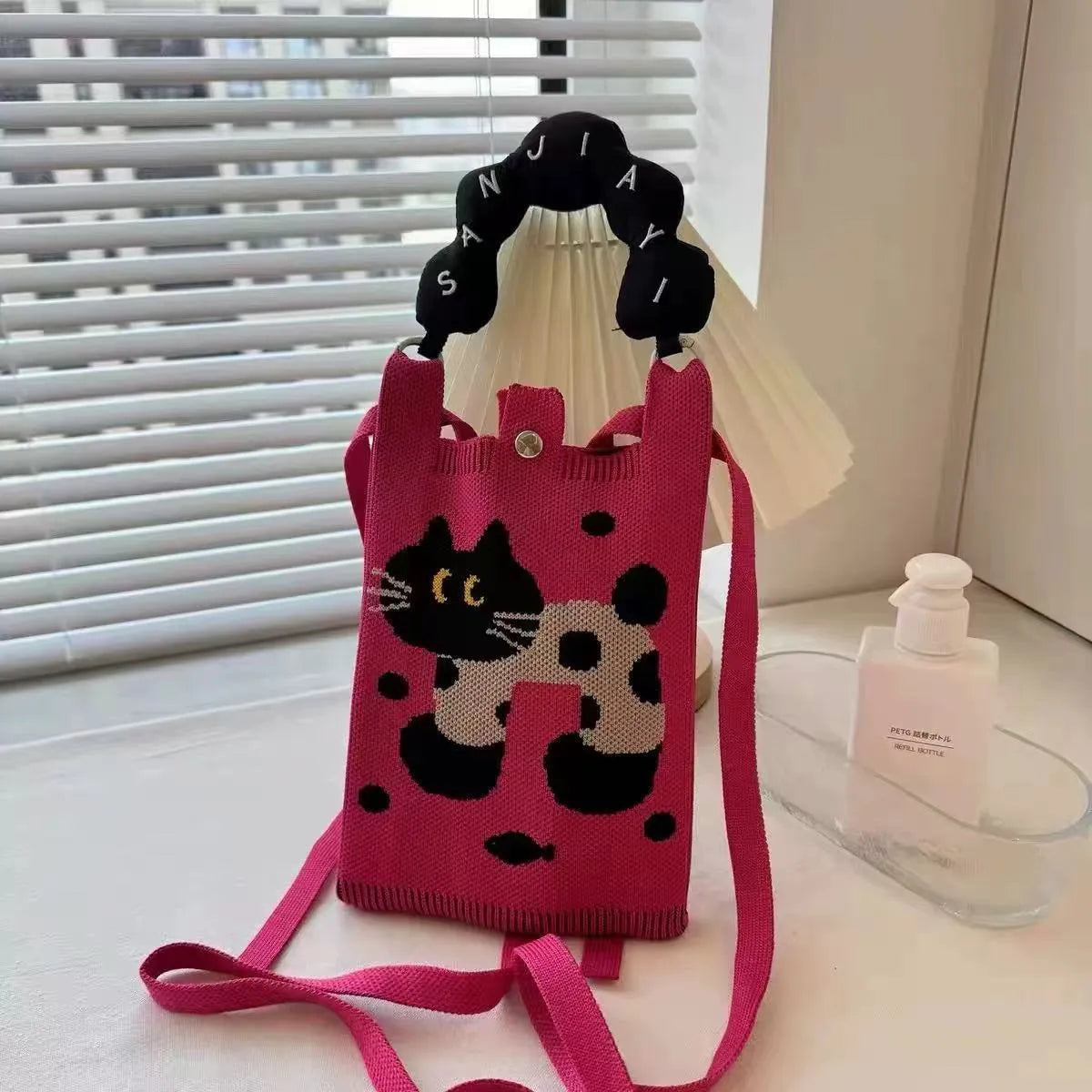 Cartoon knitted messenger bag with polyester construction and internal mobile phone storage