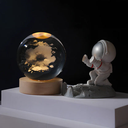 Cosmos Series crystal ball night light with wooden base and astronaut figure, showing Milky Way light pattern