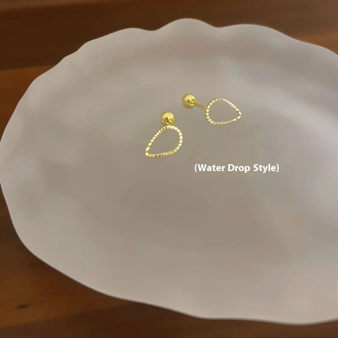 Pair of small spiral geometric ear studs with gold hollow thread finish in mixed material, shown in eight shape options.