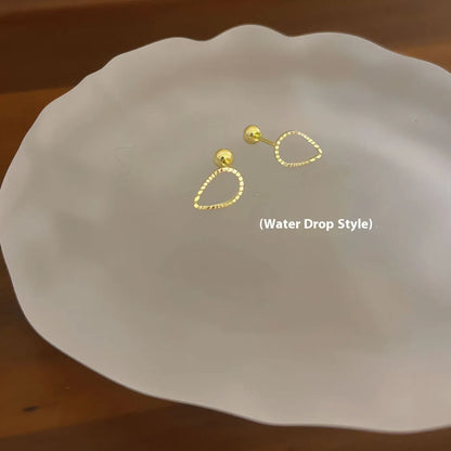 Pair of small spiral geometric ear studs with gold hollow thread finish in mixed material, shown in eight shape options.