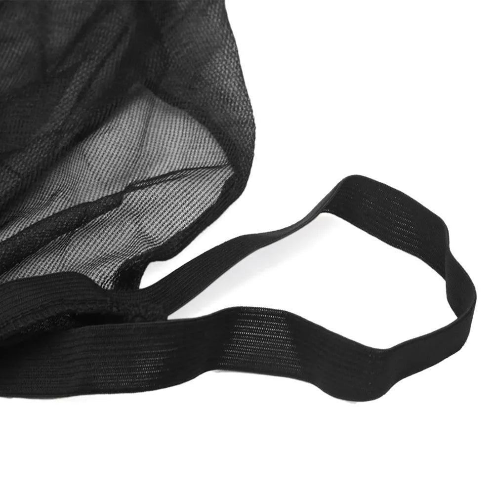 Elastic car side window sunshade made of grey non-woven mesh, stretched over a car window frame.