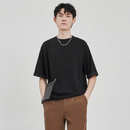 Men's brown drape knit loose t-shirt with short sleeves on a hanger.