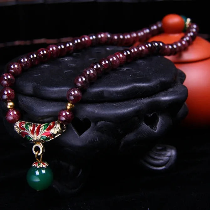 Natural garnet bracelet with 7mm stones, double ring design and golden toad charm