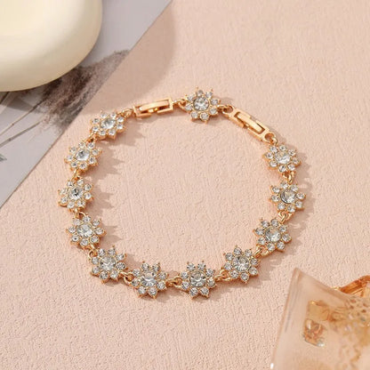 Gold and silver electroplated bracelets with flower charms set with coloured gemstones.
