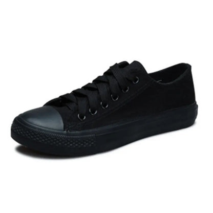 Women's solid-colour canvas casual shoes in black, shown from the side.